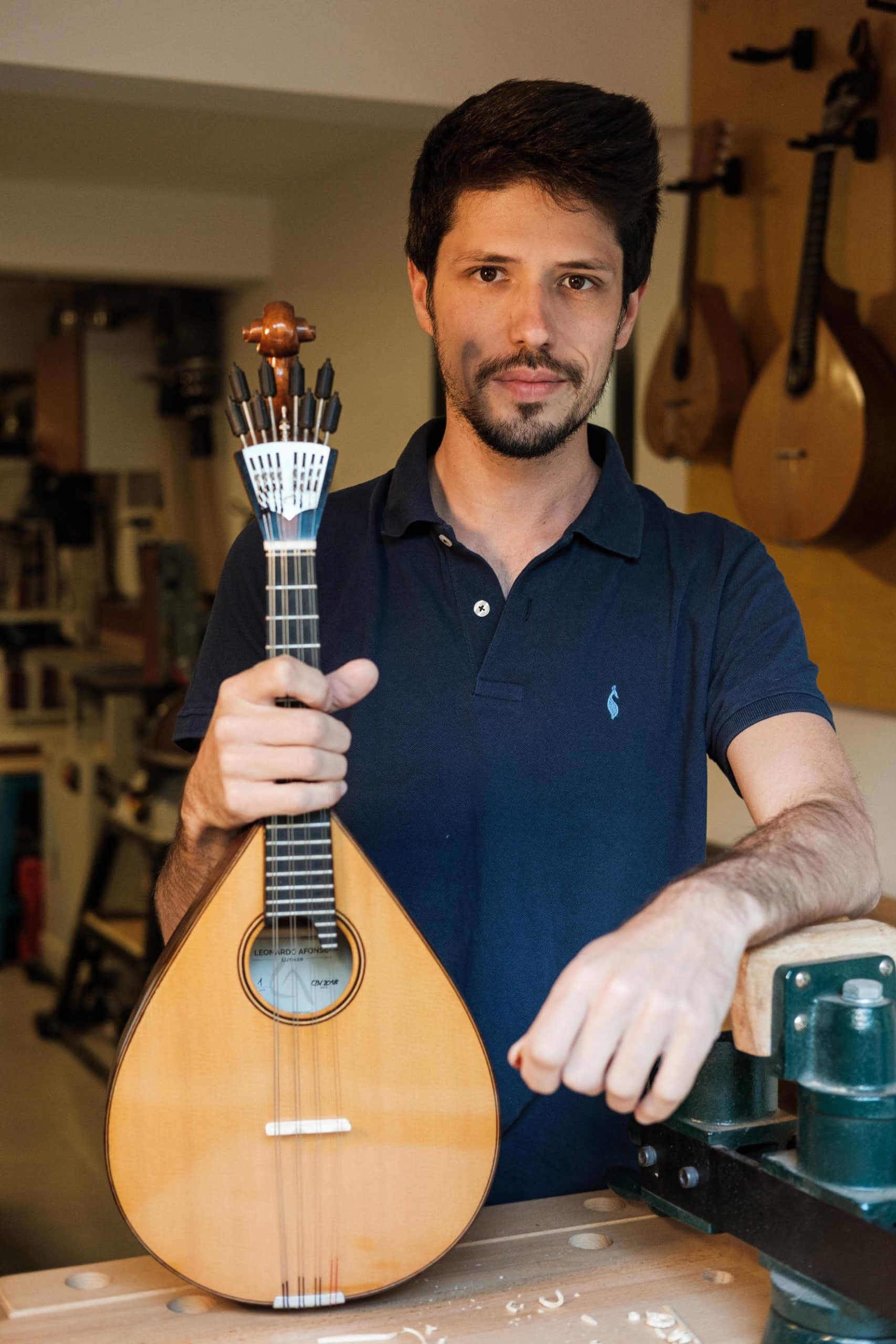 Portrait of the artist Leonardo Afonso posing with one of his guitars.